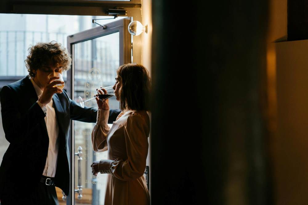 A man and woman drinking from a wine glass