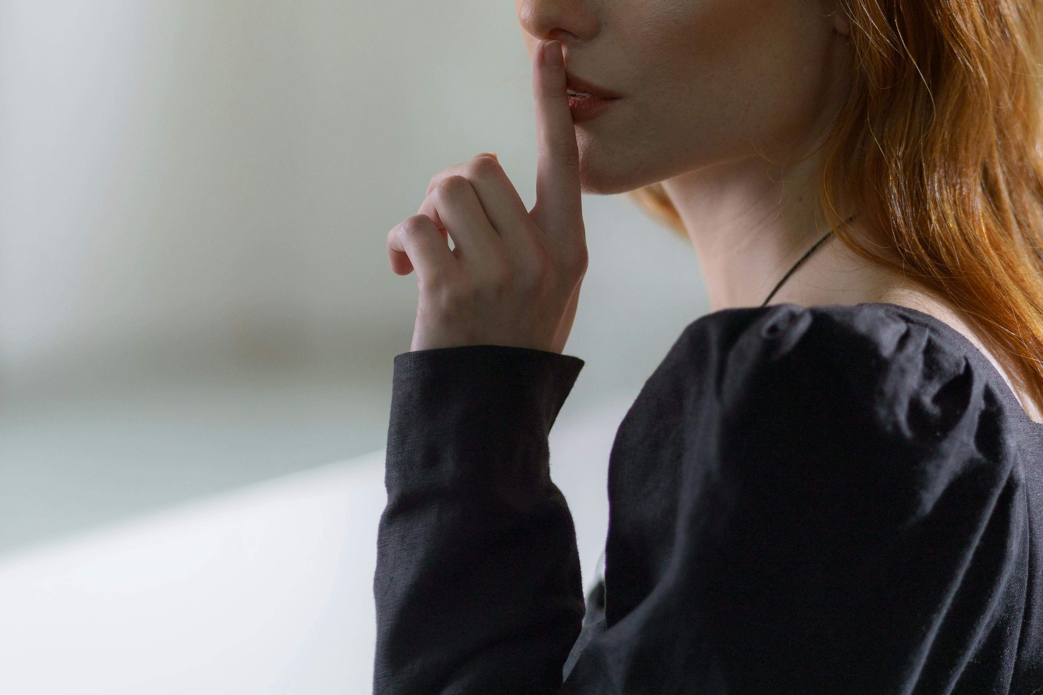 Woman holding a finger to her lips