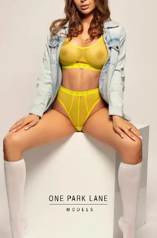 Bella sitting with her legs open, revealing her see-through panties